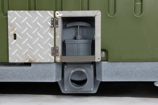 Protected portable toilet discharge valve designed to reduce tampering and leakage risk